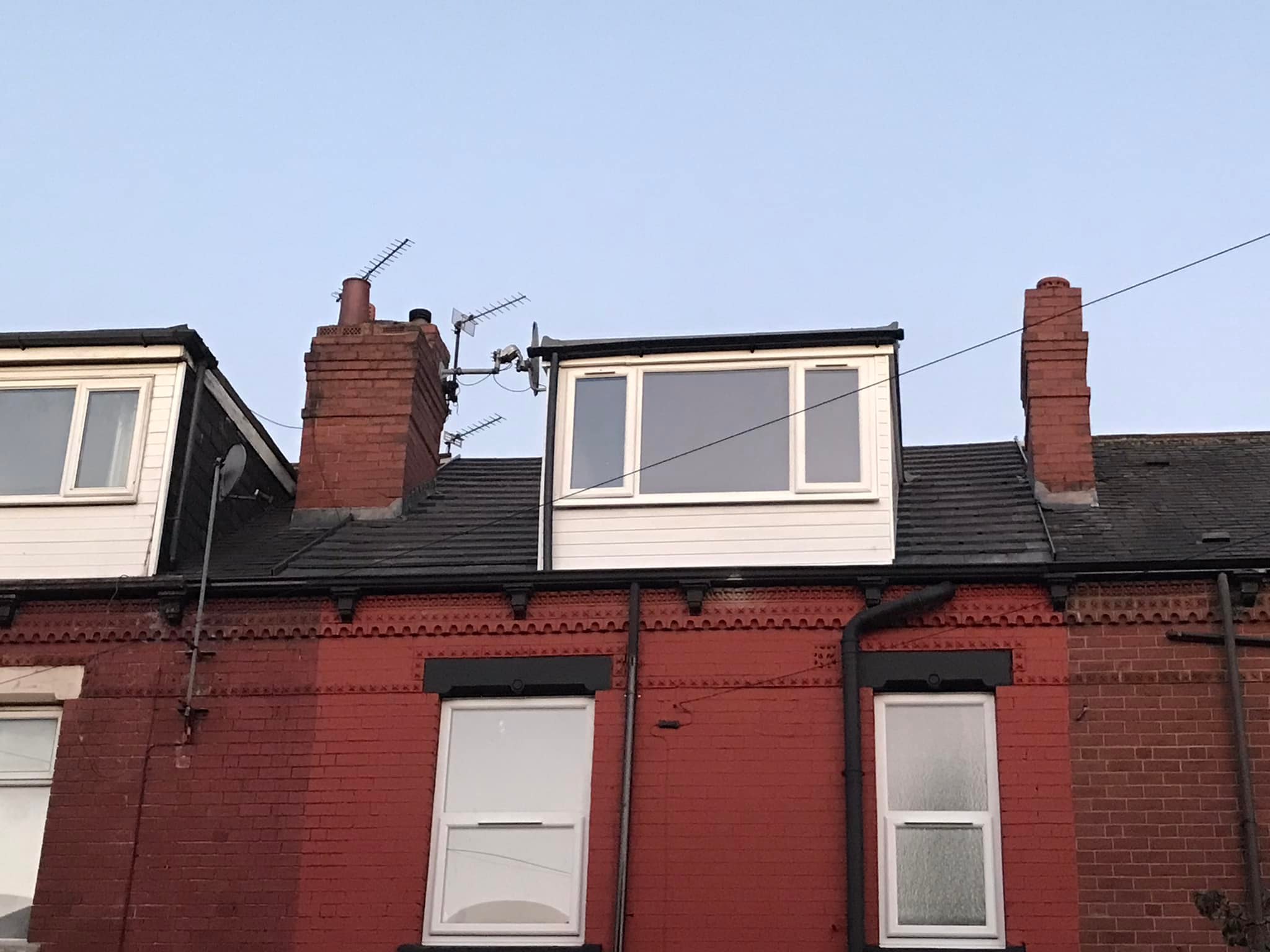 Terraced house roof with dormer loft conversion and slate tiles in Leeds