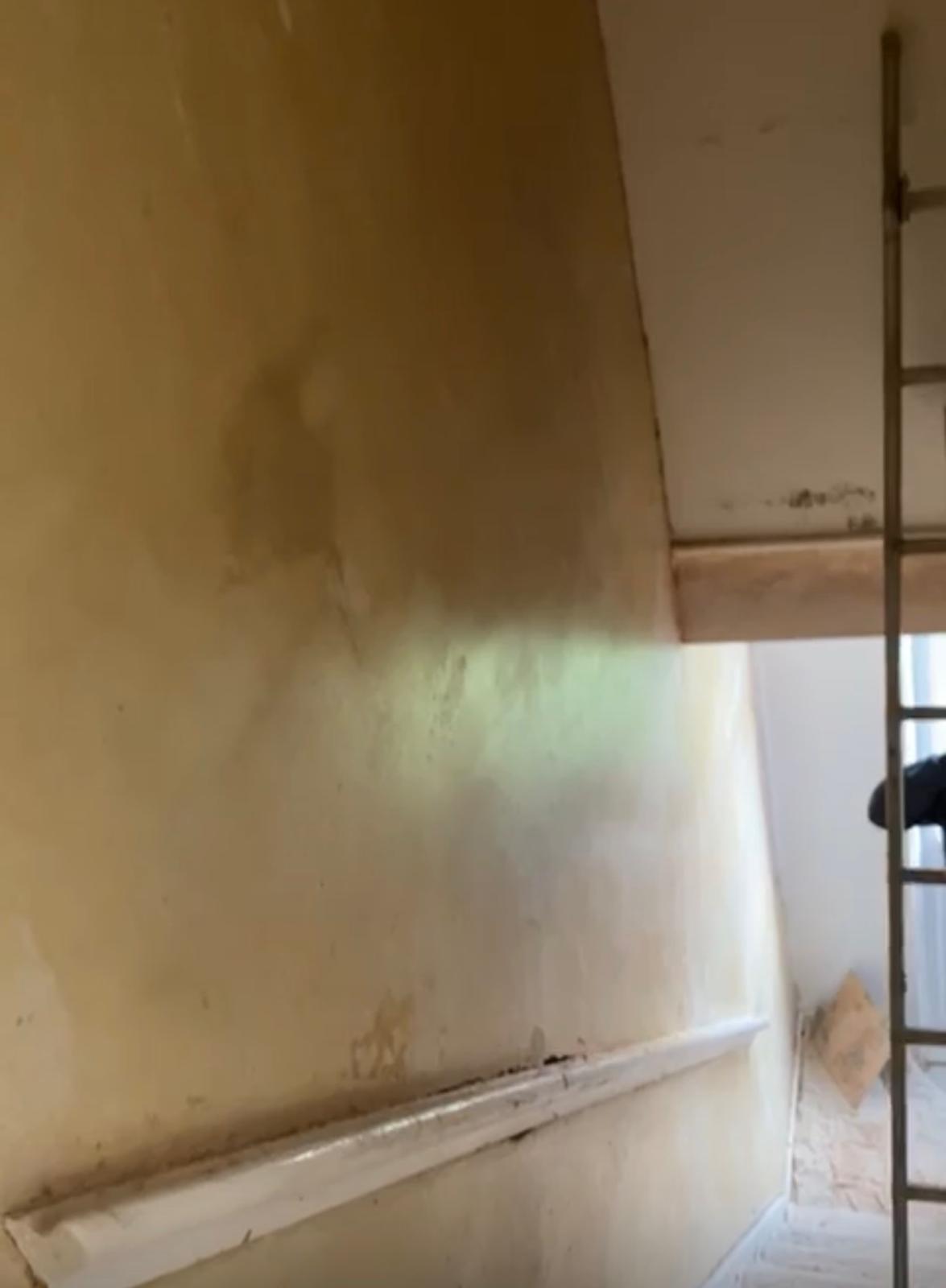 Water damaged staircase wall before plastering repair in Leeds