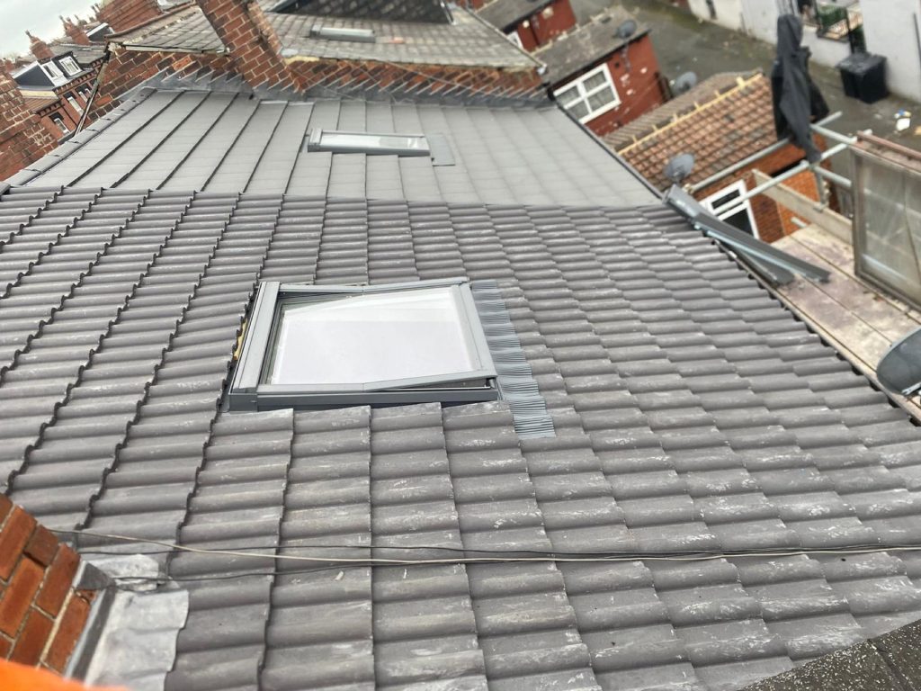 Close-up of new pointing on the bedded ridge tiles of a recently completed roof.